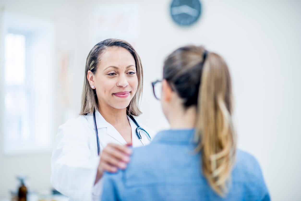 Physician Comforting An Adult Patient