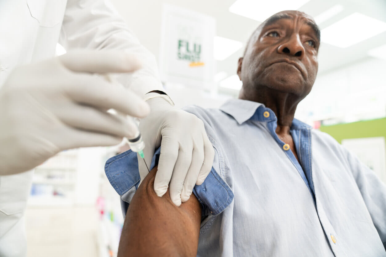 Senior man gets vaccinated for flu.